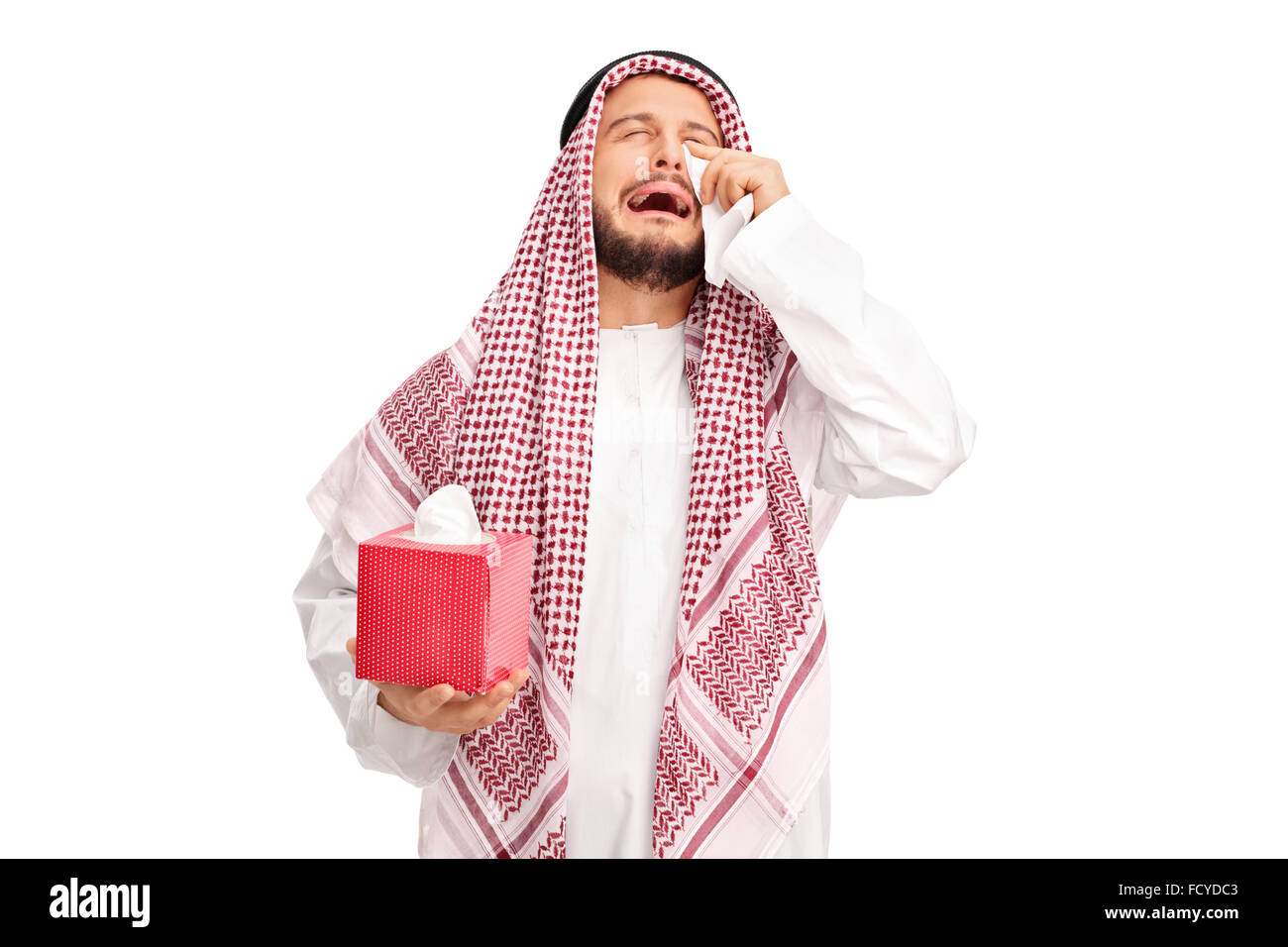 Sad young Arab crying and wiping his tears with wipes isolated on white background Stock Photo