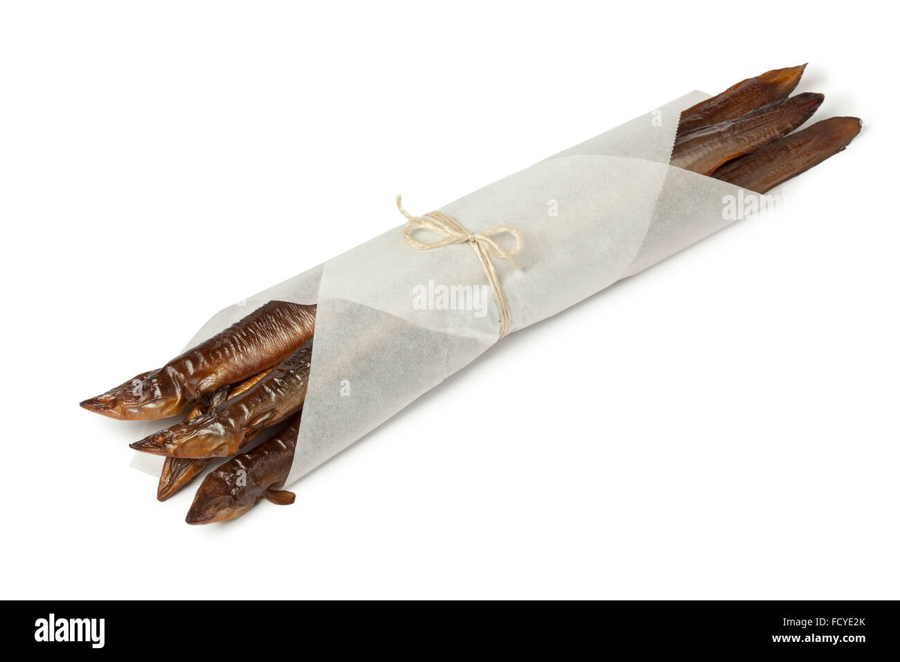 Smoked eels wrapped in paper on white background Stock Photo