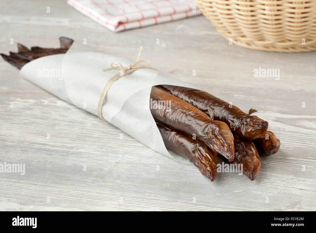 Bunch of smoked eels wrapped in paper Stock Photo
