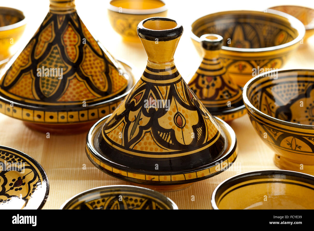 Traditional Moroccan ceramic yellow tagines on the market Stock Photo
