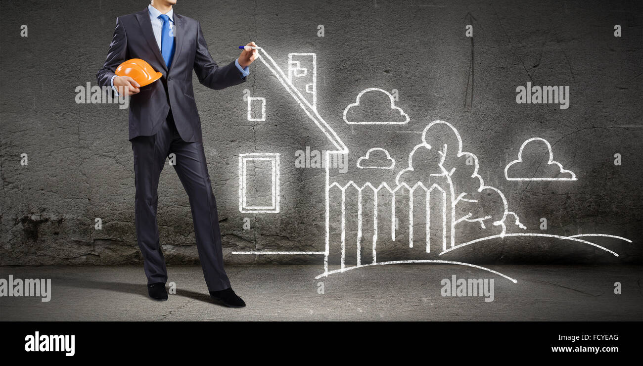 Young man engineer in helmet drawing construction project Stock Photo ...