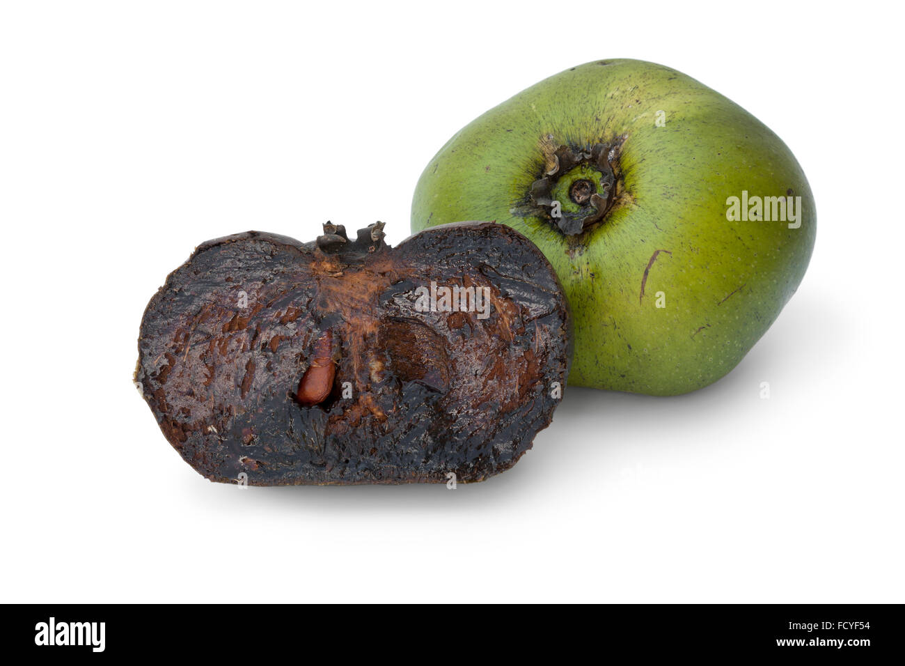 Fresh whole unripe and half black ripe sapote fruit on white background Stock Photo