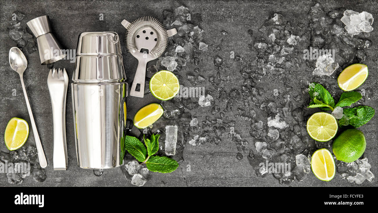 Accessories and ingredients for cocktail lime, mint, ice. Drink making. Top view Stock Photo