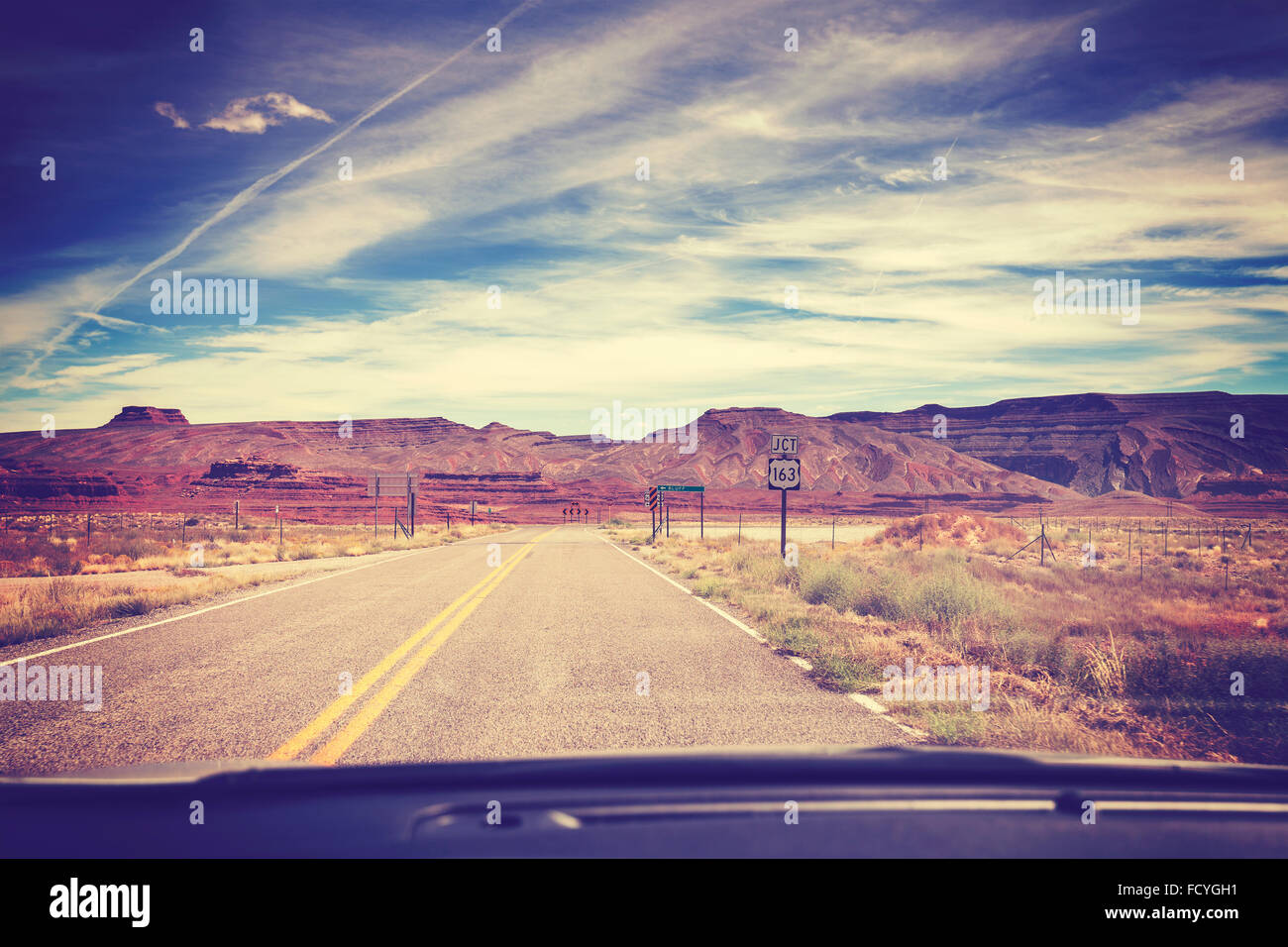 Vintage filtered road, photo taken from the front seat of a car, travel concept, USA. Stock Photo