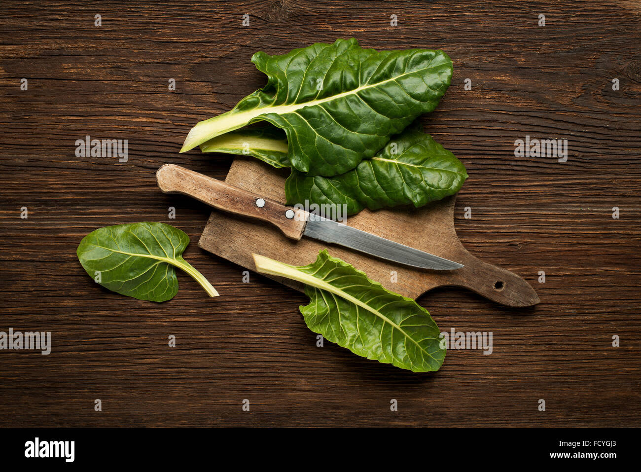 Fresh swiss chard leaves on a wooden background. Stock Photo