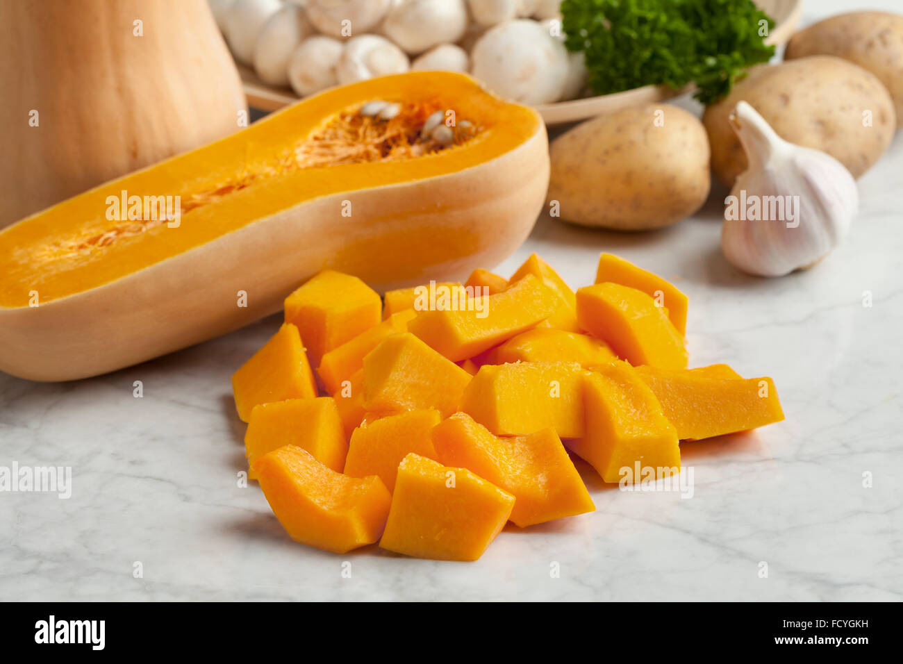 Fresh butternut pumpkin cut into pieces Stock Photo