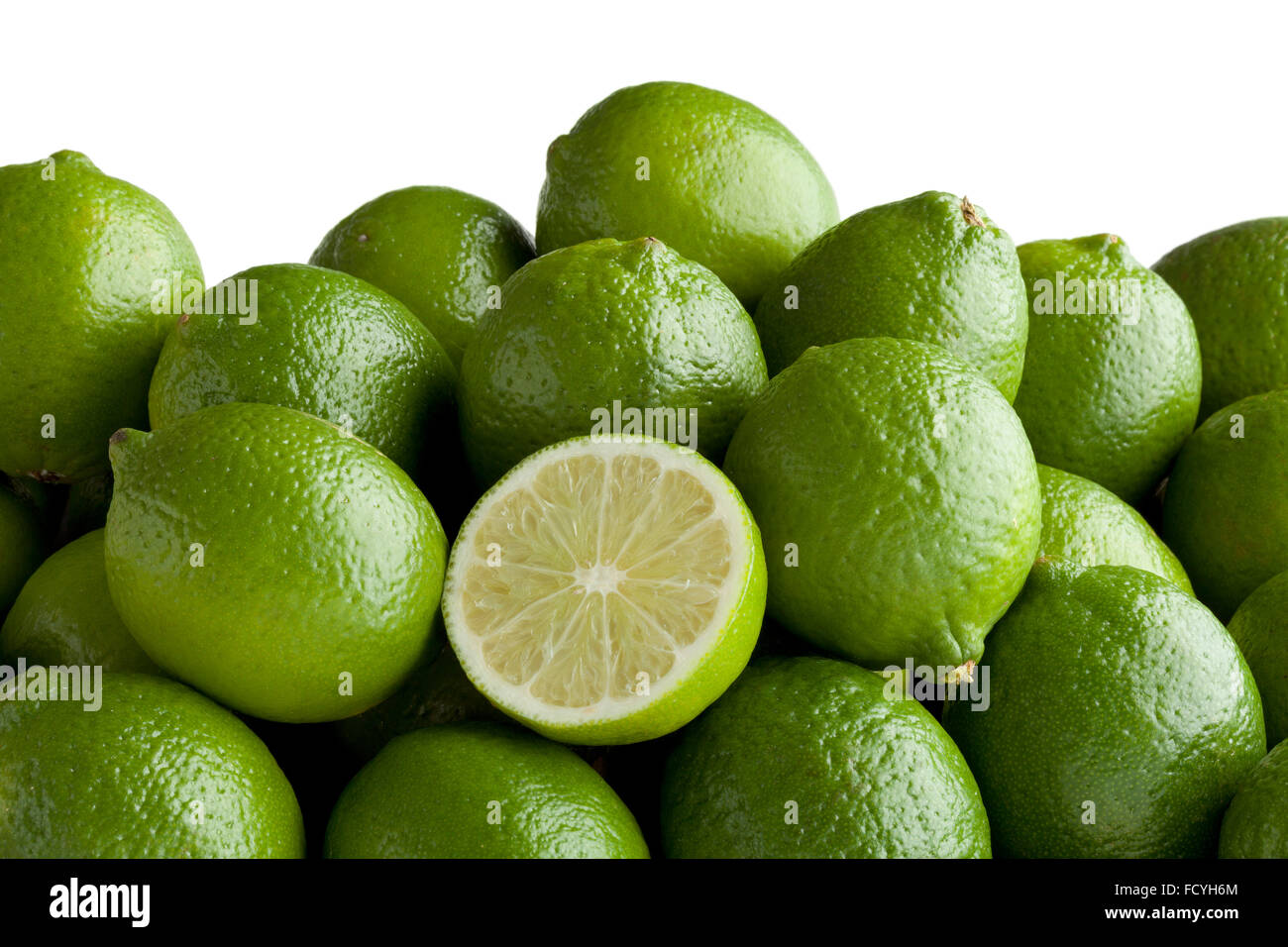 Fresh green limes and a half one Stock Photo
