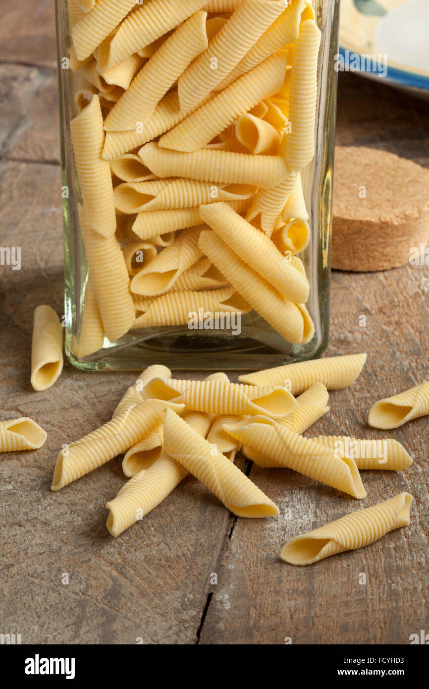 Traditional Italian handmade garganelli pasta in a glass jar Stock Photo
