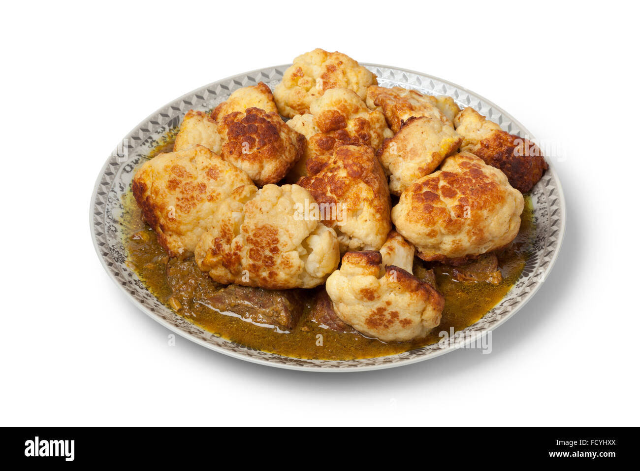 Moroccan traditional deep fried cauliflower with beef and sauce on a dish on white background Stock Photo