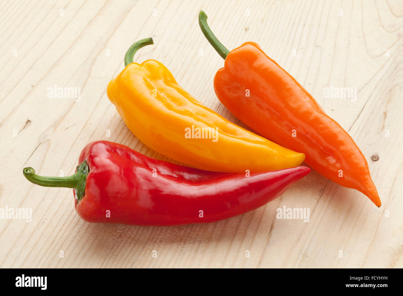 Fresh sweet red, yellow and orange pointed bell peppers Stock Photo