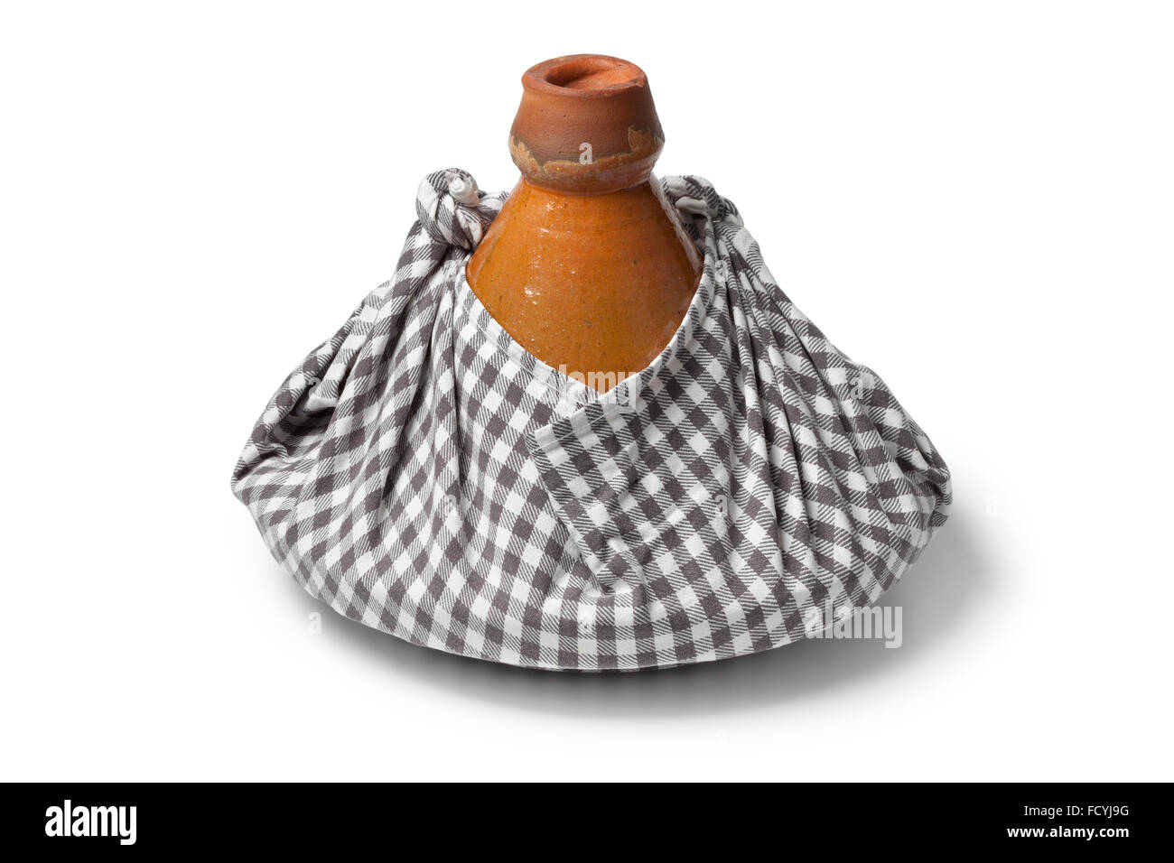 Traditional Moroccan tagine wrapped in a cloth as a gift and to keep warm on white background Stock Photo