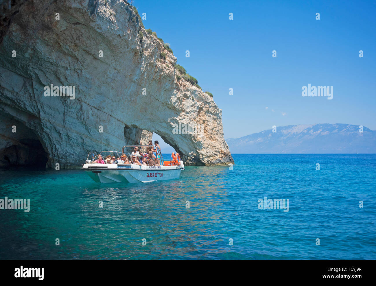 Glass bottomed tourist boat by the blue caves on the island of Zakynthos, in Greece Stock Photo