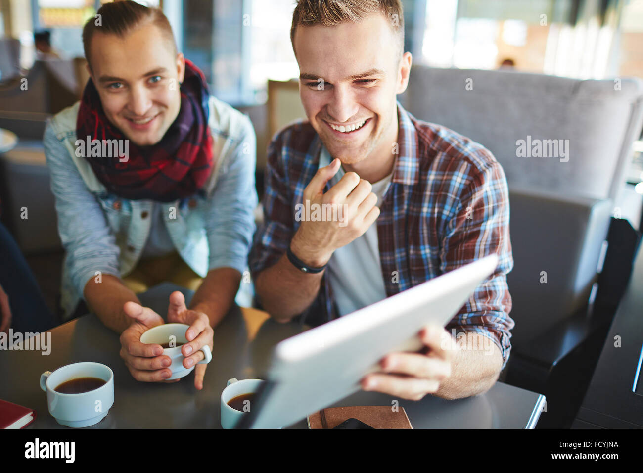 Friendly guys networking and drinking coffee in cafe Stock Photo Alamy