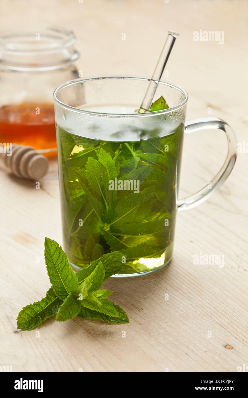 Tea glass with mint tea and honey Stock Photo