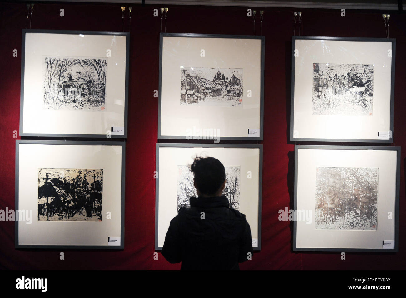 Harbin, China's Heilongjiang Province. 26th Jan, 2016. A visitor views an exhibition of ice engraving painting in Harbin, capital of northeast China's Heilongjiang Province, Jan. 26, 2016. The pictures on display were printed from engraved ice slabs, according to artist Zhu Xiaodong. He said each ice slab was able to print out some 20 pages yielding variant results as the ice melted down. © Wang Song/Xinhua/Alamy Live News Stock Photo