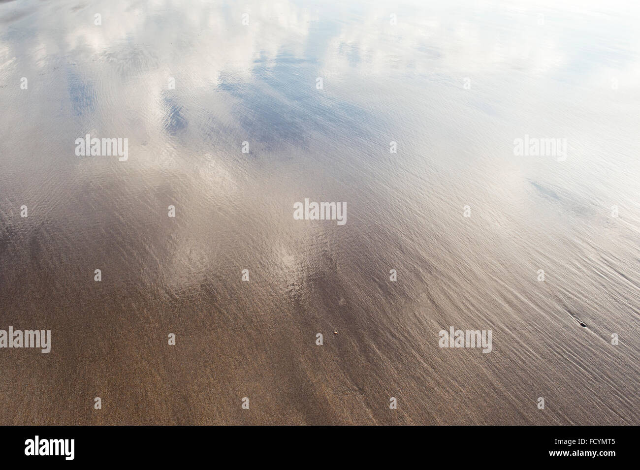 Wet sand beach cloud reflection coastline abstract Stock Photo