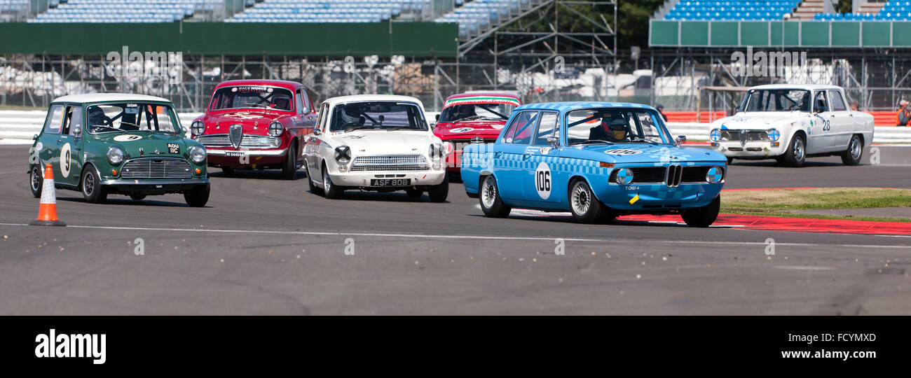 Close racing during the Warwick Banks Trophy for Under 2 litres Touring Cars, Silverstone Classic 2015. Stock Photo