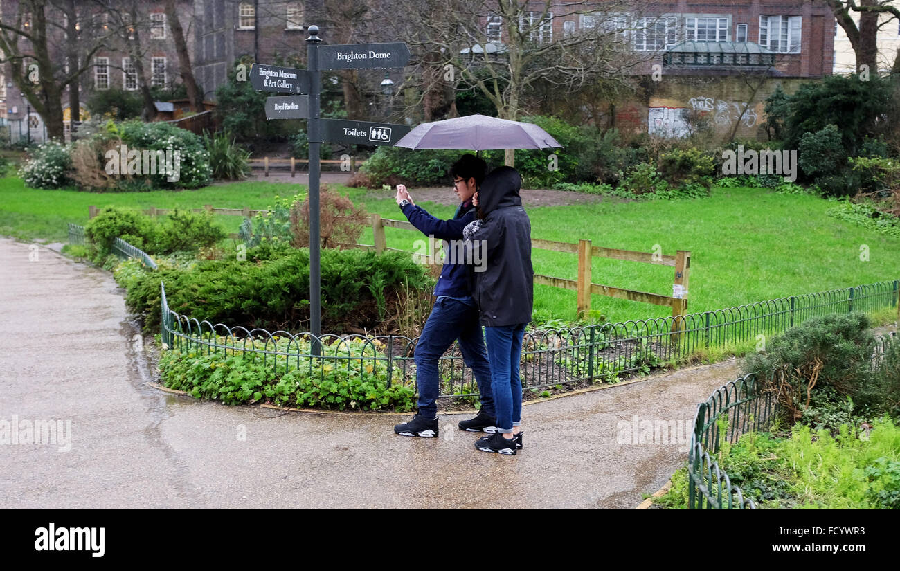 Brighton, UK. 26th January, 2016. A couple struggle with their umbrella in Brighton today as the storm weather which caused snow chaos in the USA arrives in Britain today bringing gales and rain   Credit:  Simon Dack/Alamy Live News Stock Photo