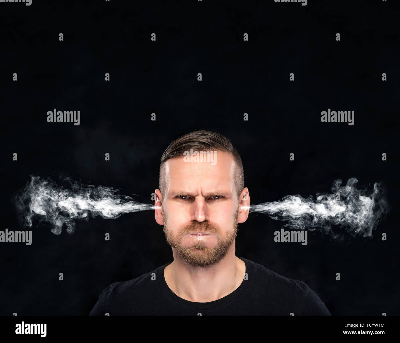 Angry man with smoke coming out from his ears. Stock Photo