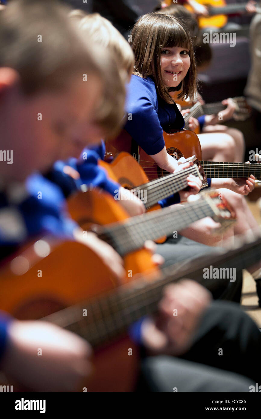 Primary school pupils take part in a guitar concert at the Bridgewater Hall , Manchester Stock Photo