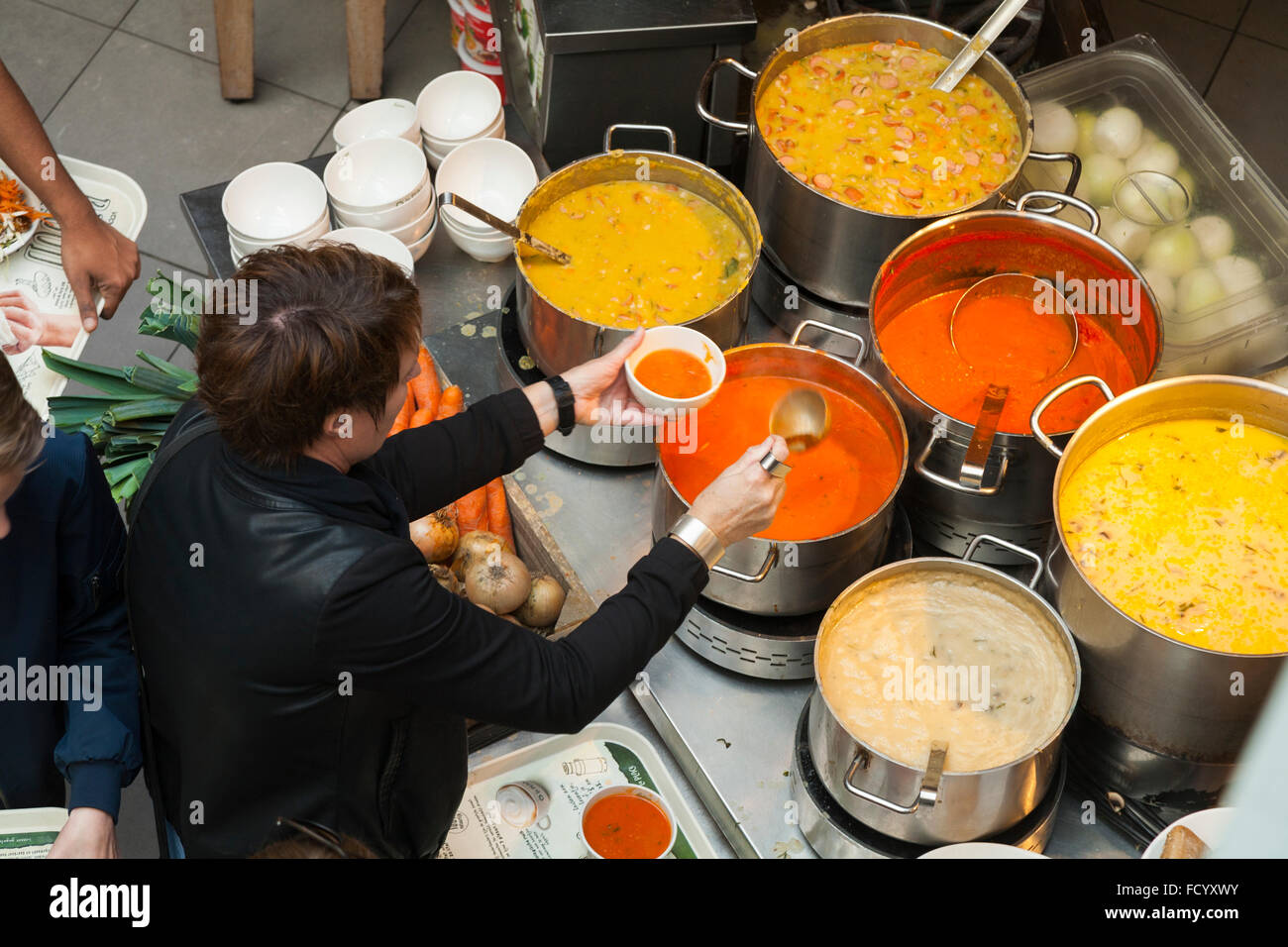 Customers serve themselves with hot soup at La Place self service food