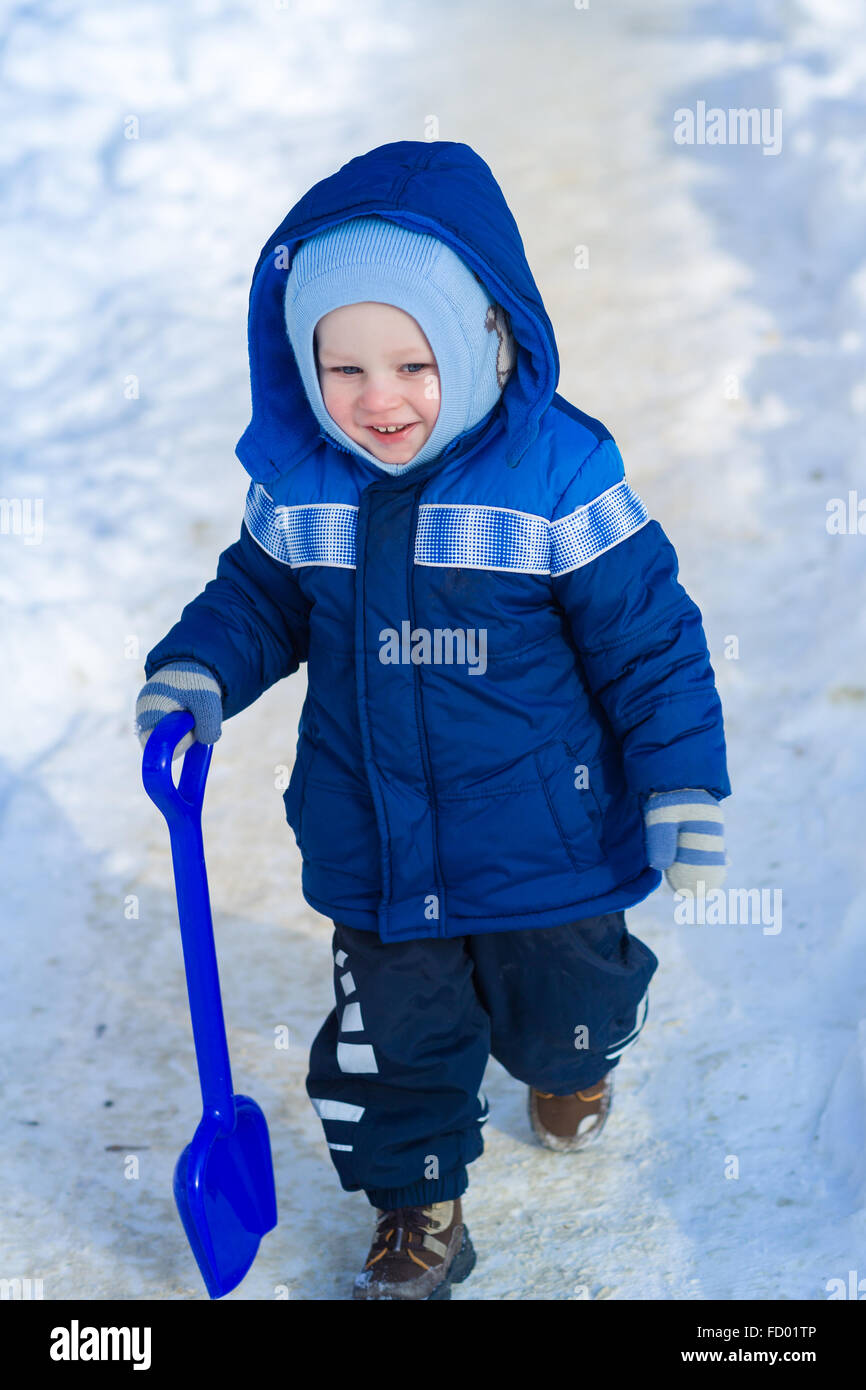 Cute Baby Boy Playing With Snow Toy Shovel In Winter Outdoor Stock