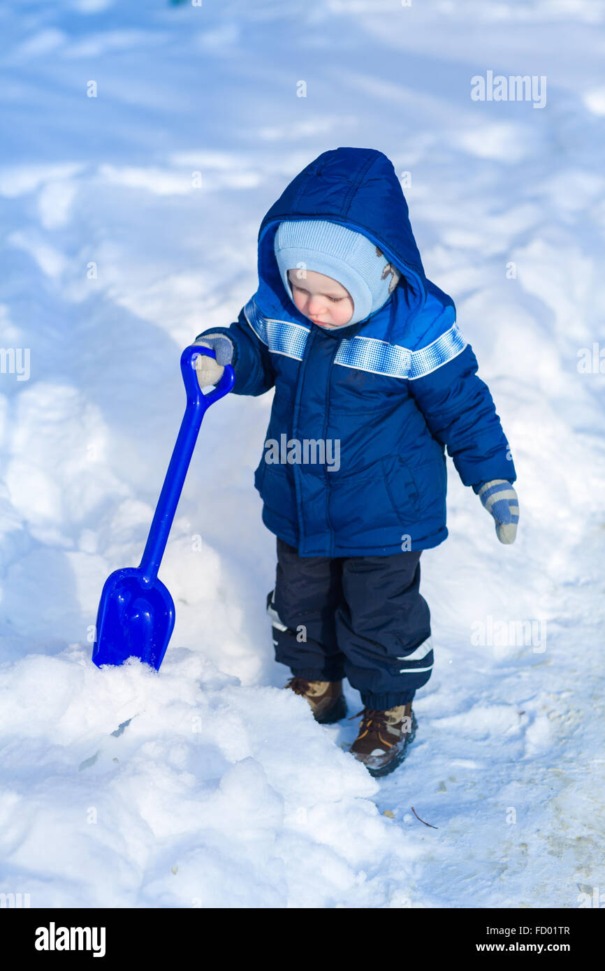 Cute Baby Boy Playing With Snow Toy Shovel In Winter Outdoor Stock