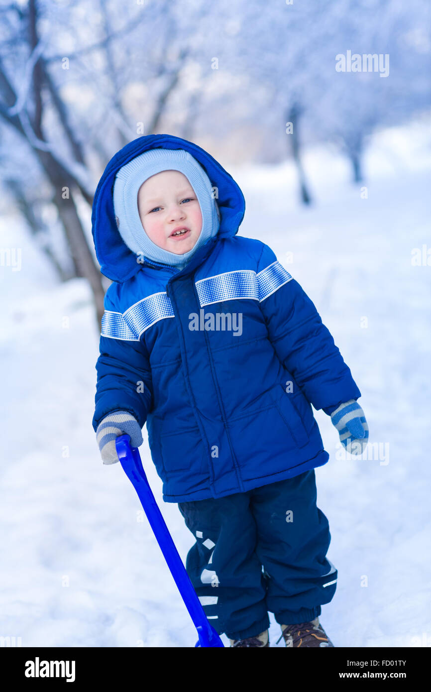 Cute Baby Boy Playing With Snow Toy Shovel In Winter Outdoor Stock