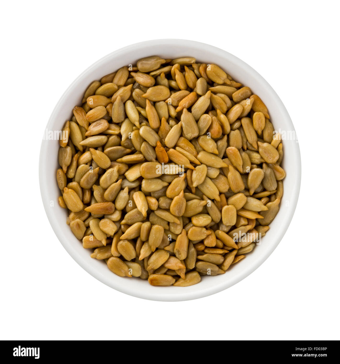 Roasted Sunflower Seeds in a ceramic bowl. The image is a cut out, isolated on a white background. Stock Photo
