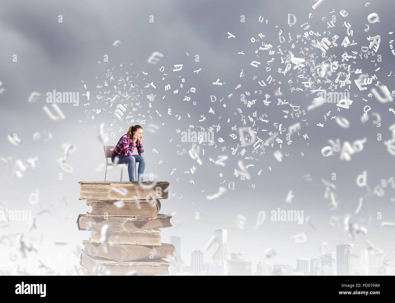 Young girl sitting on high pile of books Stock Photo - Alamy