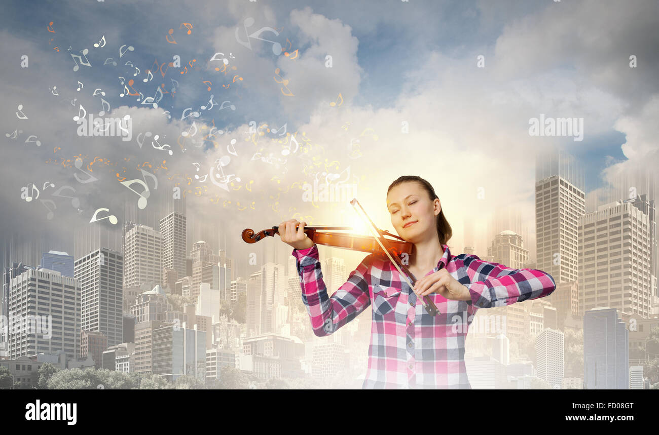 Young pretty woman in casual playing on violin Stock Photo - Alamy