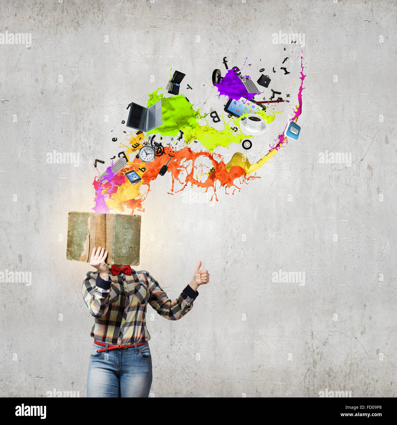 Woman in casual wear hiding her face behind book Stock Photo