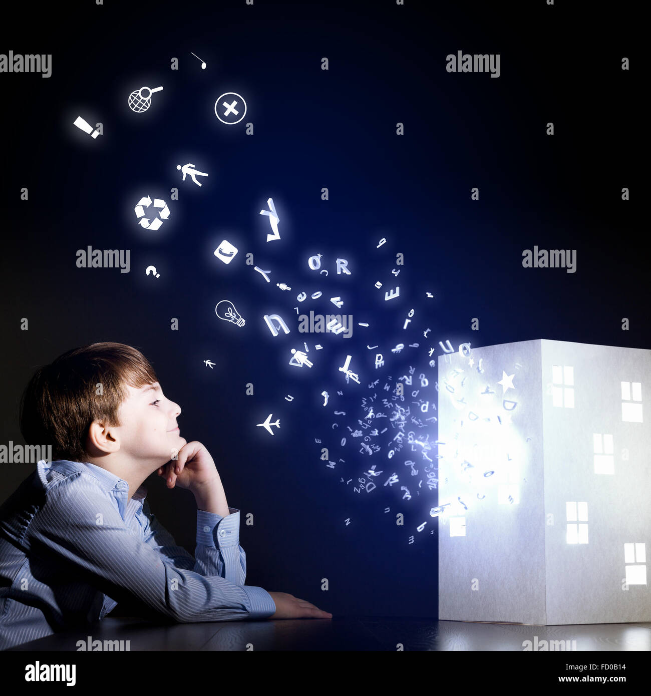 Cute little boy looking at model of house Stock Photo - Alamy