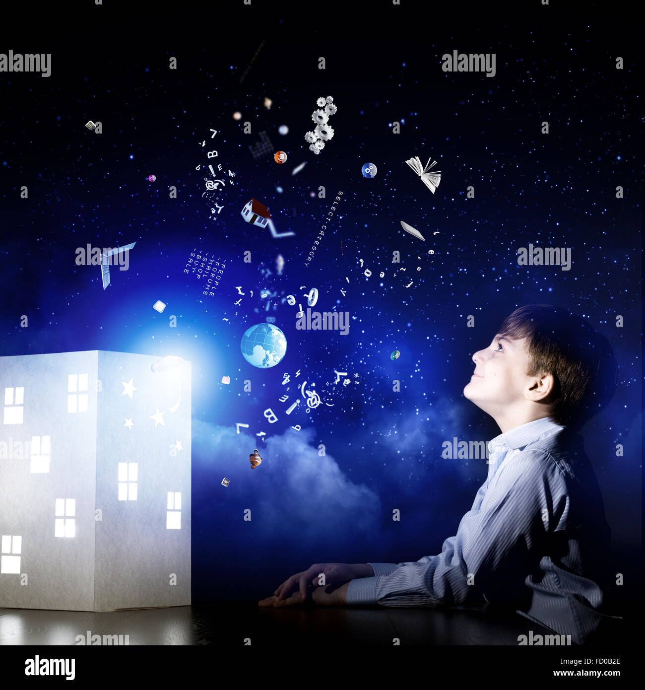 Cute little boy looking at model of house Stock Photo - Alamy