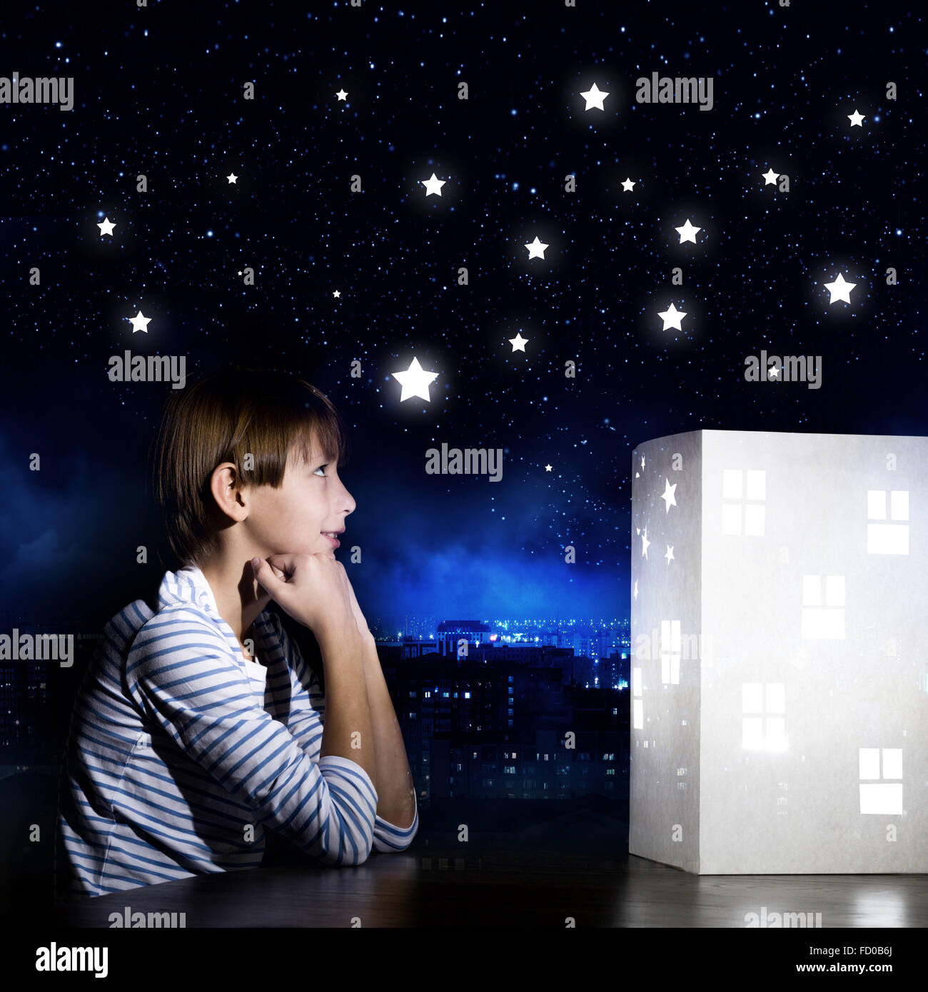 Cute little boy looking at model of house Stock Photo - Alamy
