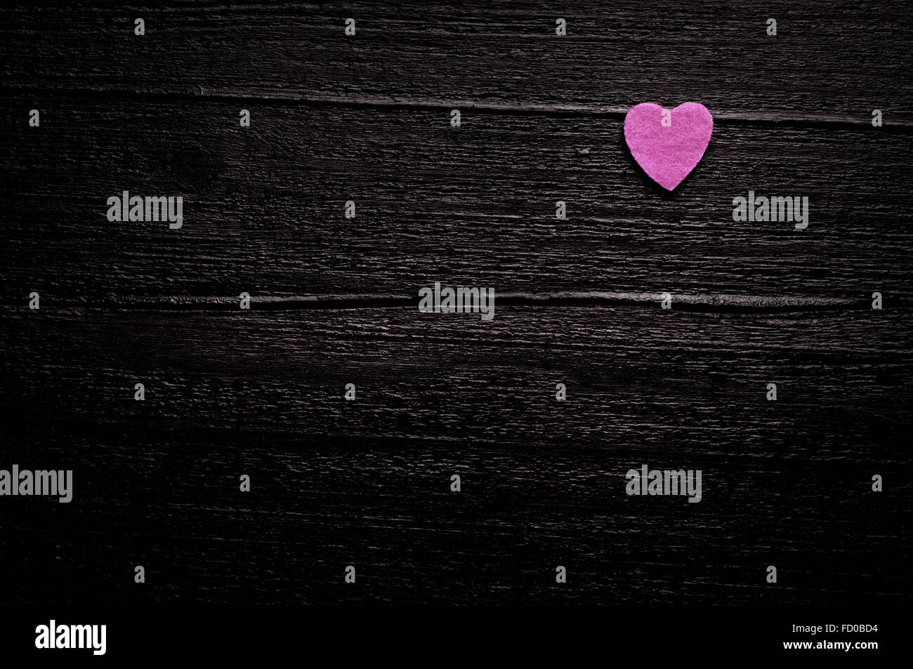 Little pink heart on a dark-brown wooden background Stock Photo