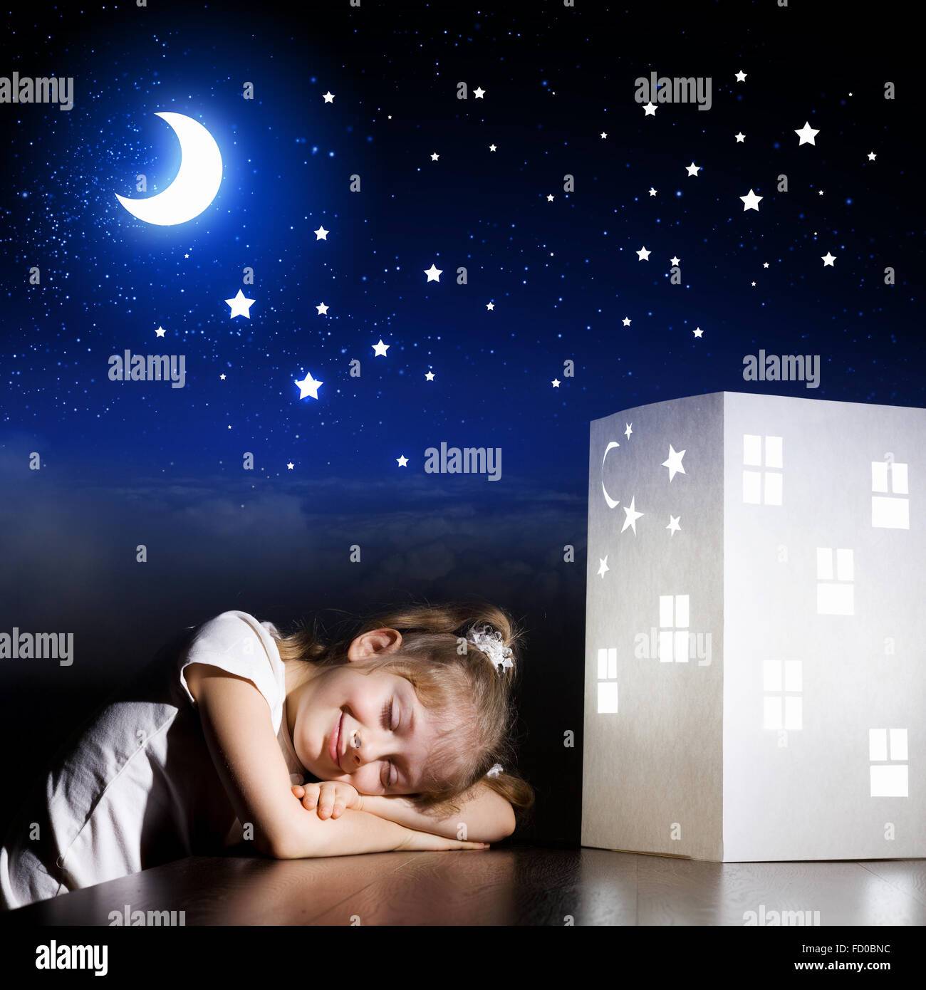 Cute little girl sleeping near model of house and dreaming Stock Photo -  Alamy