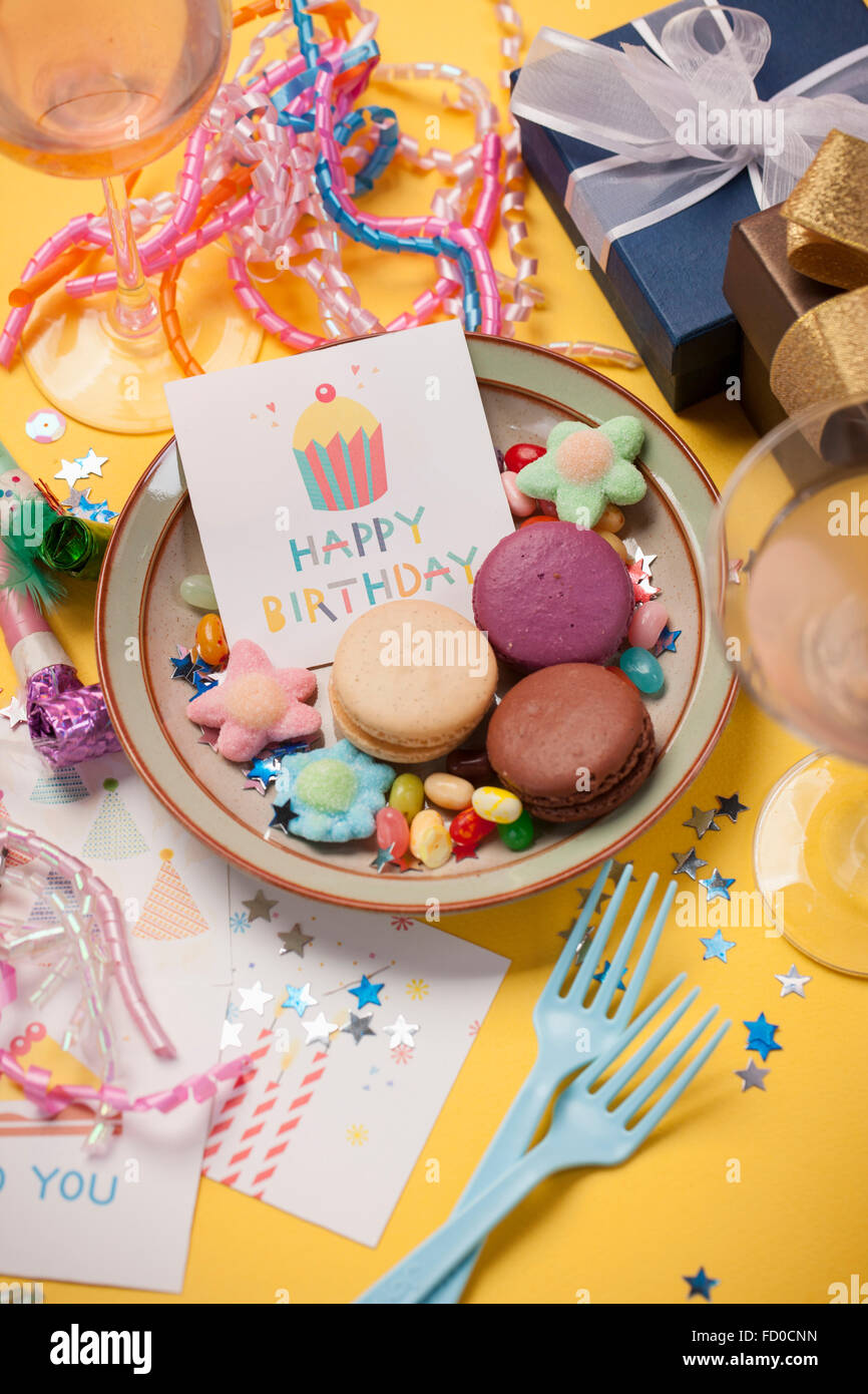 High angle of colorful sweets and birthday card with many different birthday celebration related objects Stock Photo