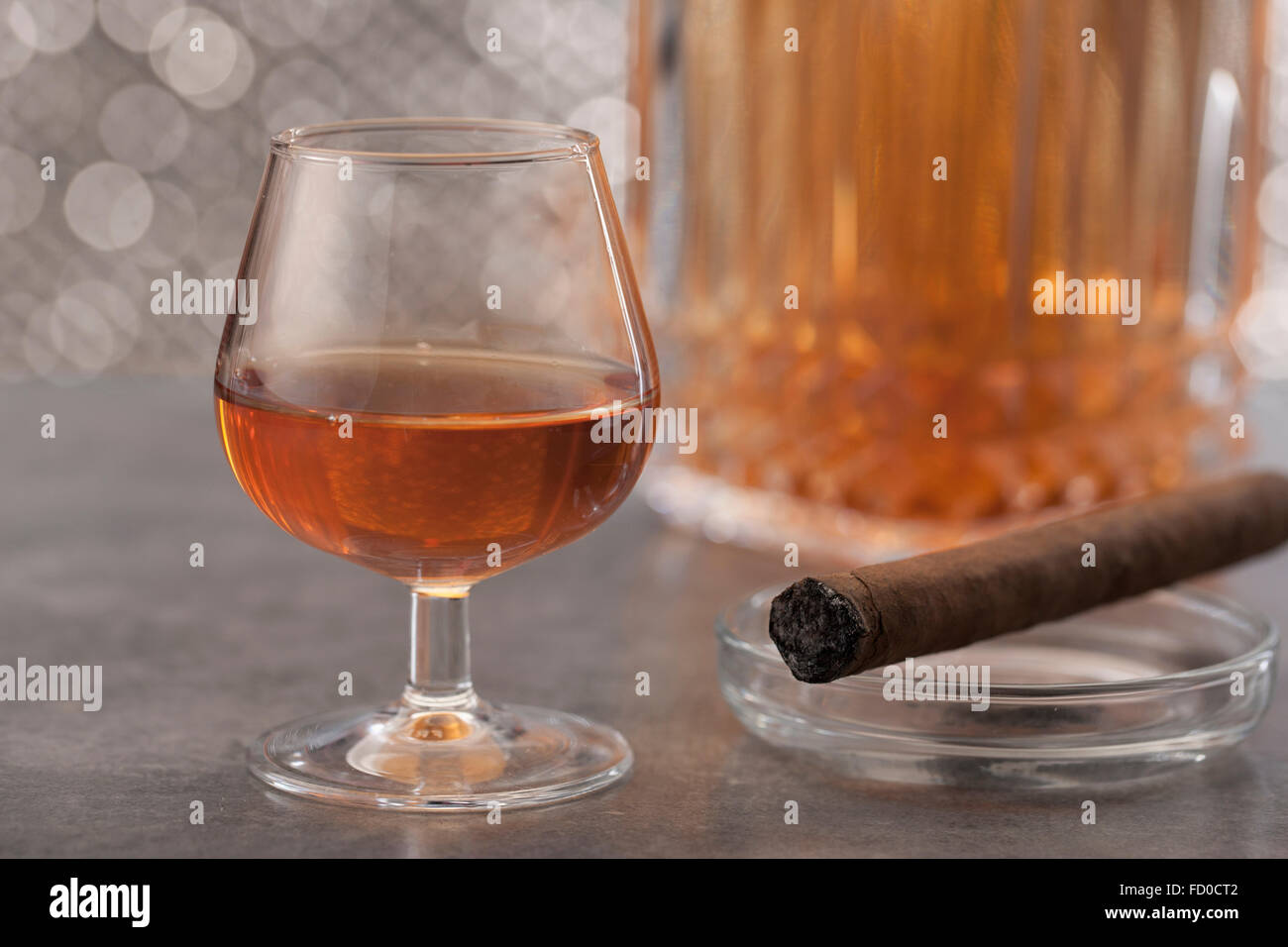 Glass of whisky and a cigar on ash tray Stock Photo