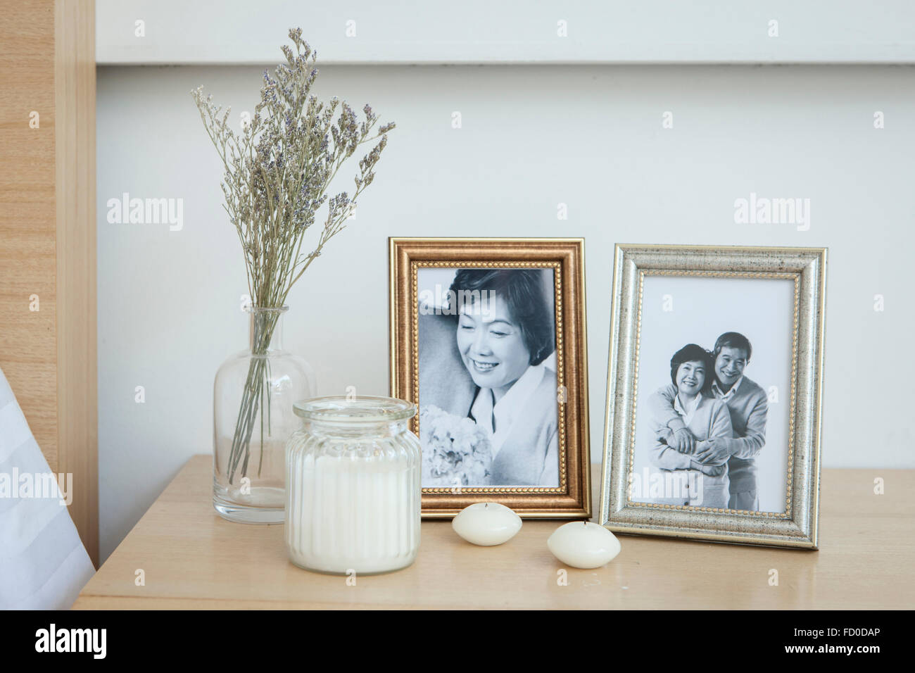 Old photos of senior couple in frames placed with other interior objects Stock Photo