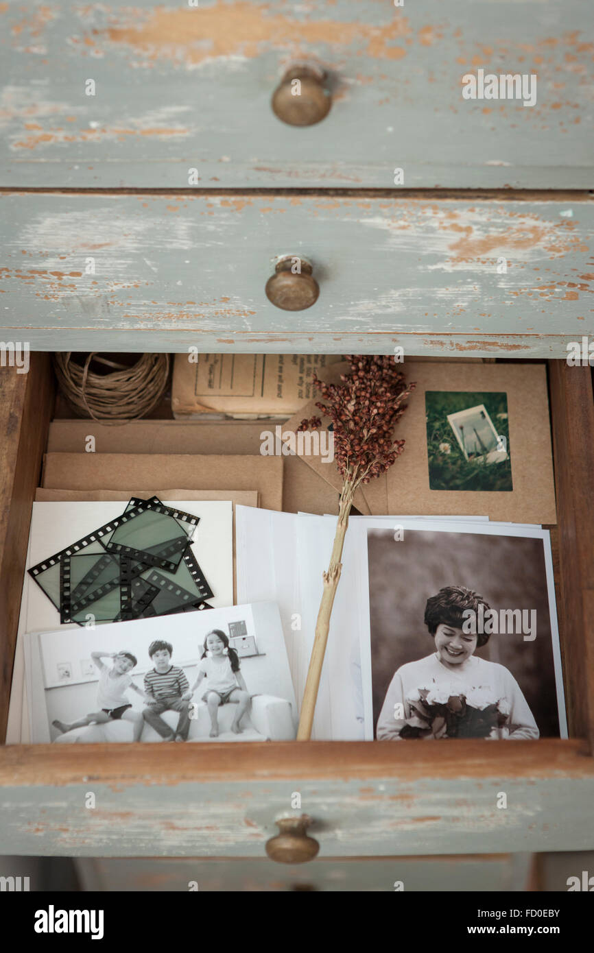 High angle of a drawer opened and old photos in it Stock Photo