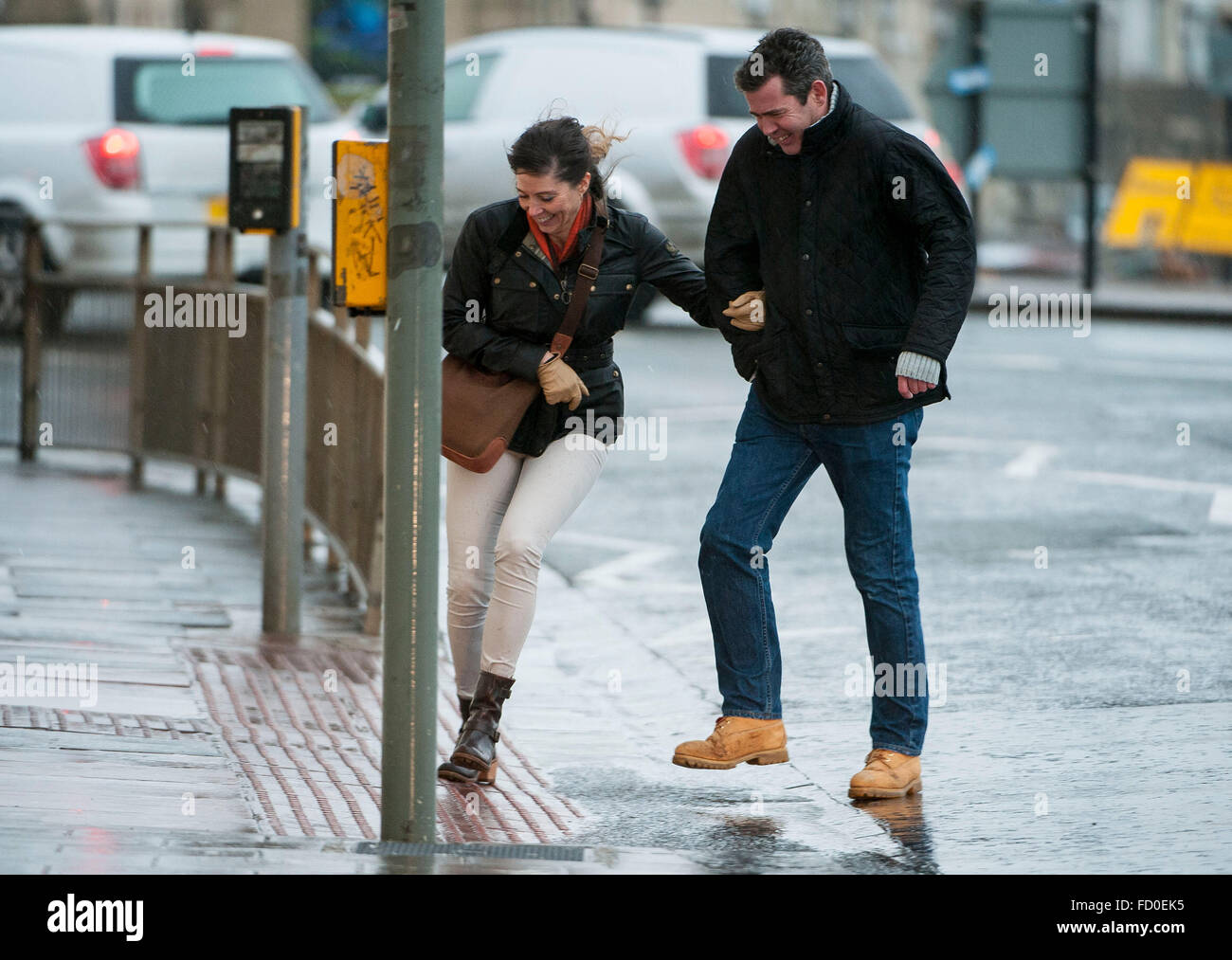 Brighton, Sussex, UK. 26th January, 2016. UK Weather: The storm which has caused snow chaos in America arrives in the UK today bringing heavy rain and high winds. Scenes of people battling the elements in Brighton, Sussex, UK. Picture taken 26/01/2016   Credit:  Darren Cool/Alamy Live News Stock Photo