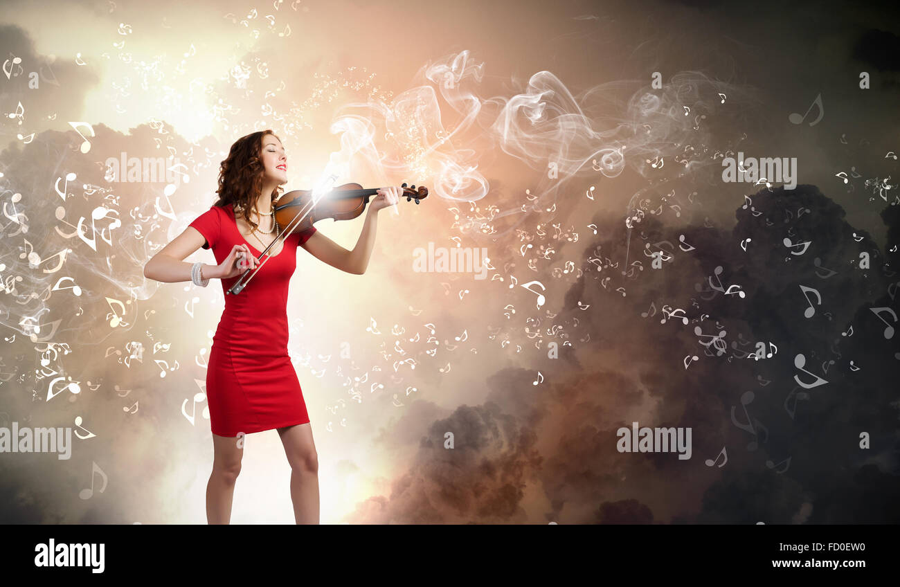 Young attractive woman in red dress playing violin Stock Photo - Alamy