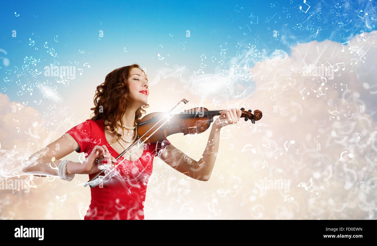 Young attractive woman in red dress playing violin Stock Photo - Alamy