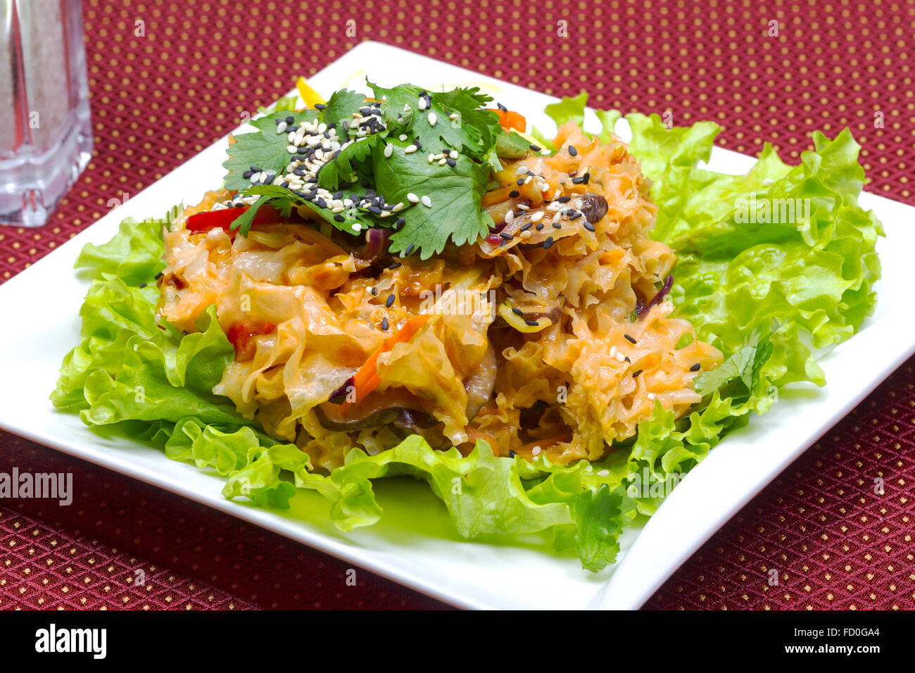 Coleslaw, green leaf lettuce and sesame seeds, selective focus. Table setting. Creative cuisine. Stock Photo