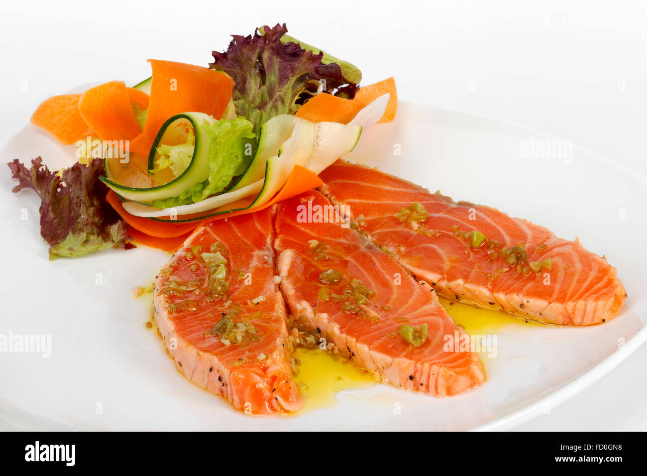 Salmon carpaccio with chopped vegetables in a restaurant Stock Photo