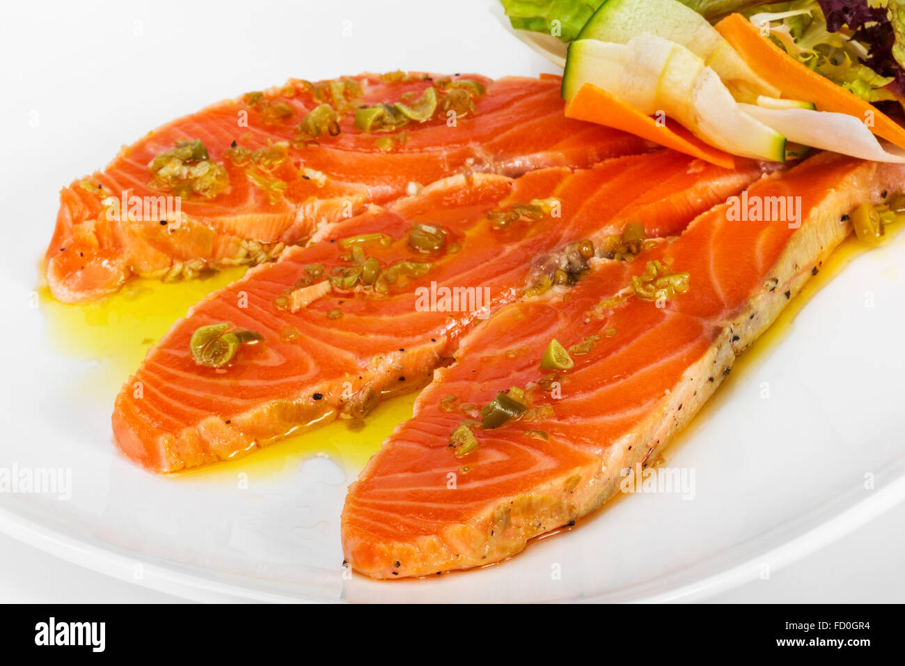 Salmon carpaccio with chopped vegetables in a restaurant Stock Photo