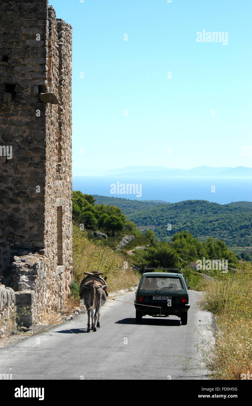 Car and donkey on the old road - Island Vis, Dalmatia, Croatia Stock Photo