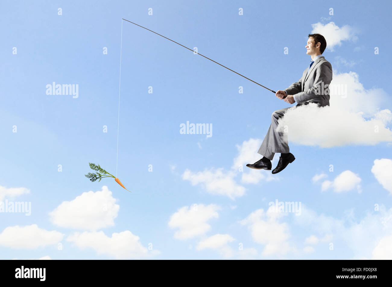 Young businessman standing on cloud high in sky and fishing Stock Photo ...