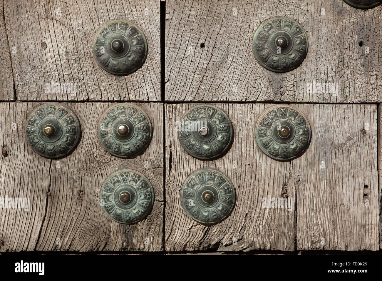 Old wooden gate fixed with large brass rivets in Albayzin district in Granada, Andalusia, Spain. Stock Photo